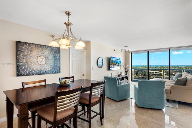 dining room featuring expansive windows, marble finish floor, and an inviting chandelier