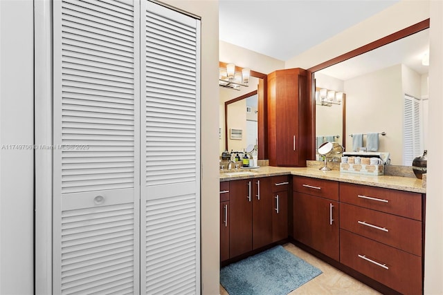 bathroom with a chandelier, a closet, and vanity