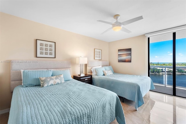 bedroom featuring light tile patterned floors, ceiling fan, a water view, access to outside, and a wall of windows