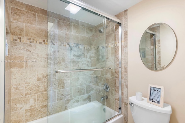 bathroom with shower / bath combination with glass door and toilet