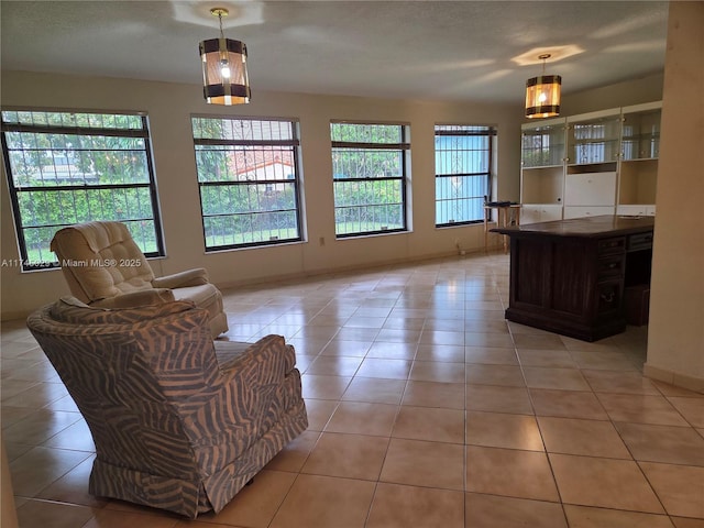 interior space with light tile patterned floors and baseboards