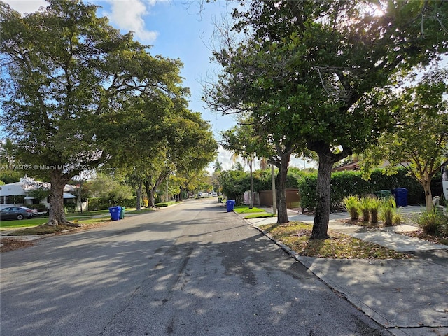 view of road with sidewalks and curbs