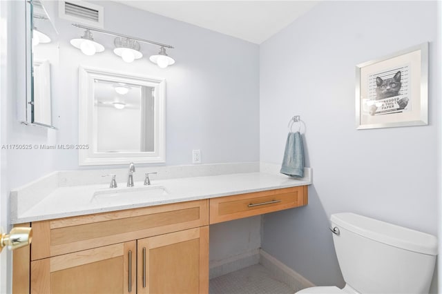 half bath with toilet, visible vents, and vanity