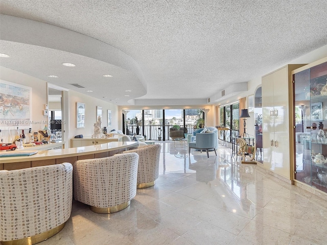 living area with a textured ceiling