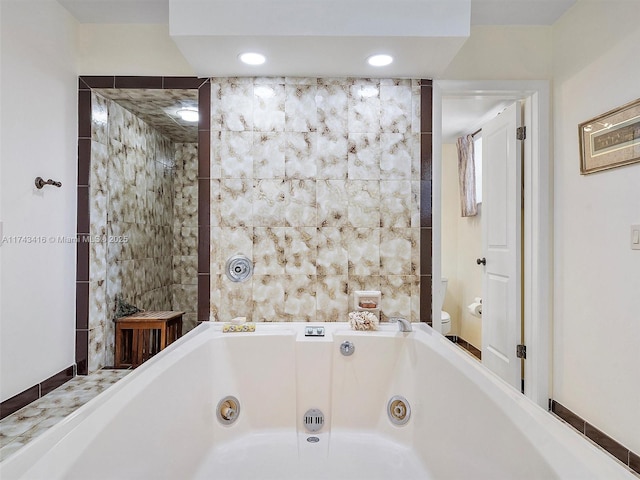 full bath with toilet, a tub with jets, tile walls, and recessed lighting