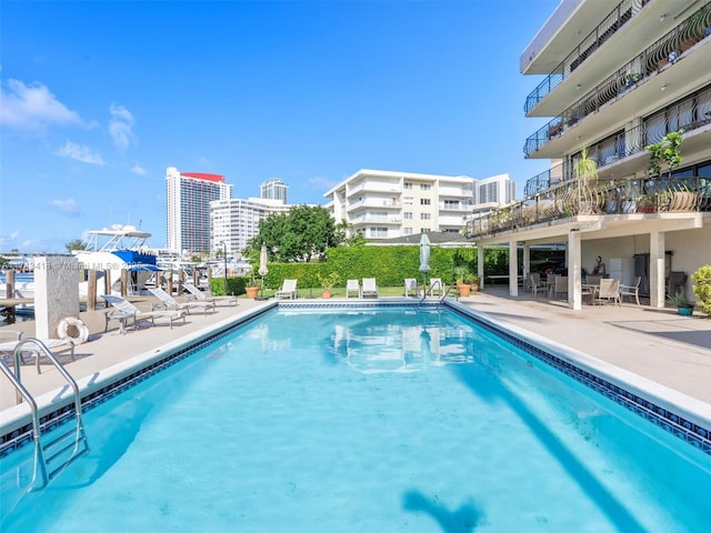 pool featuring a view of city and a patio