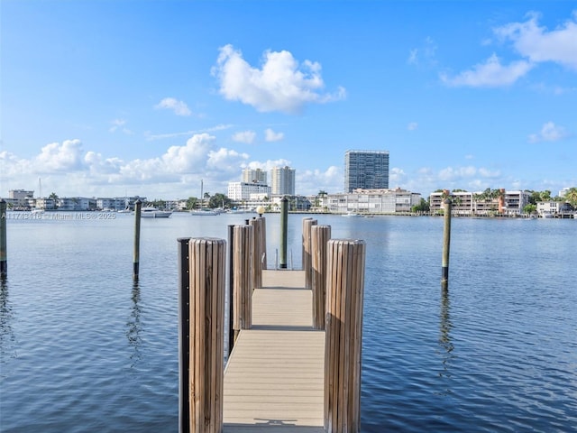 view of dock featuring a water view and a city view