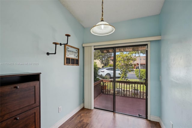 entryway with wood finished floors and baseboards