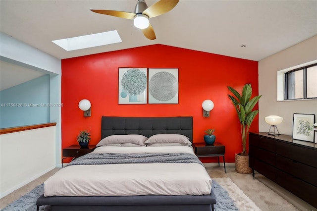 carpeted bedroom with lofted ceiling with skylight, a ceiling fan, and baseboards