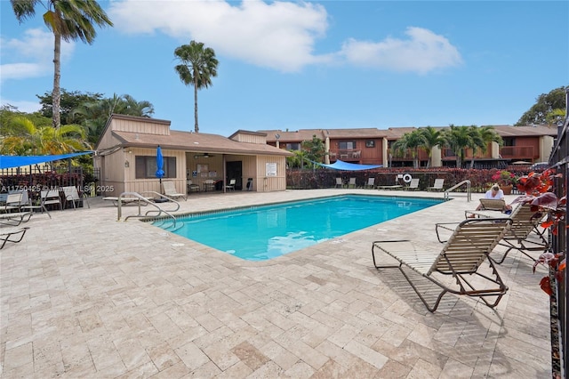 pool with fence and a patio area