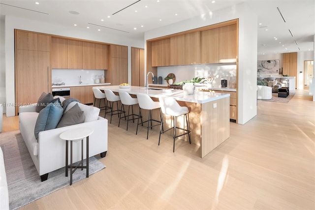 kitchen featuring open floor plan, light countertops, and a spacious island