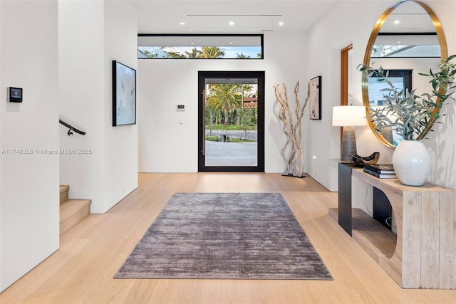 entryway featuring stairway and light wood-style flooring