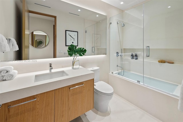 bathroom featuring shower / bath combination with glass door, vanity, and toilet