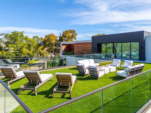 view of community with a lawn and fence