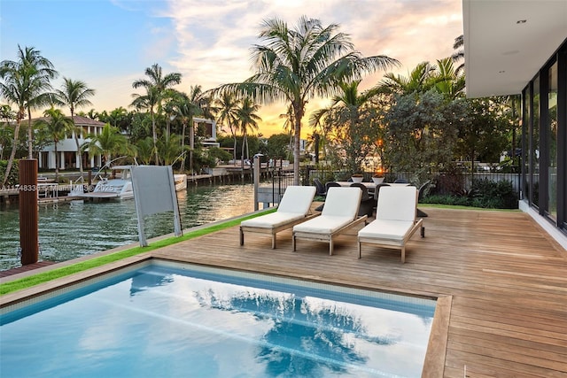 view of swimming pool featuring a water view