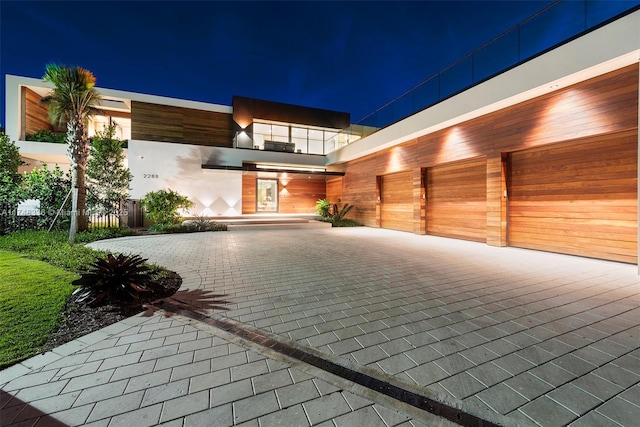 exterior space with a garage and decorative driveway