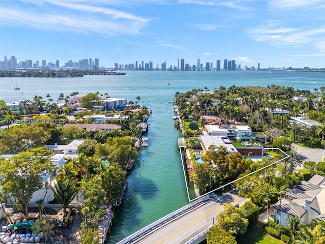 birds eye view of property with a water view and a view of city