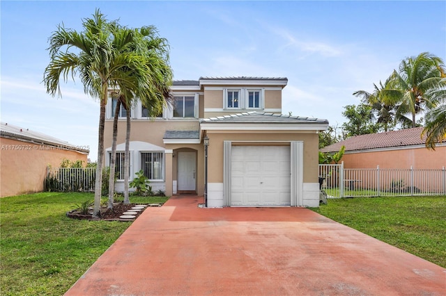 view of front of property with concrete driveway, a front lawn, fence, and stucco siding