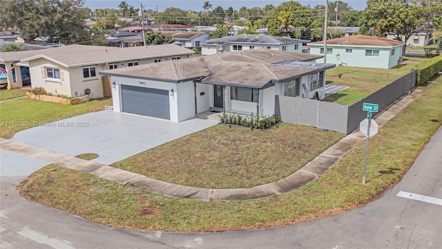 ranch-style home with a front yard, a residential view, and an attached garage