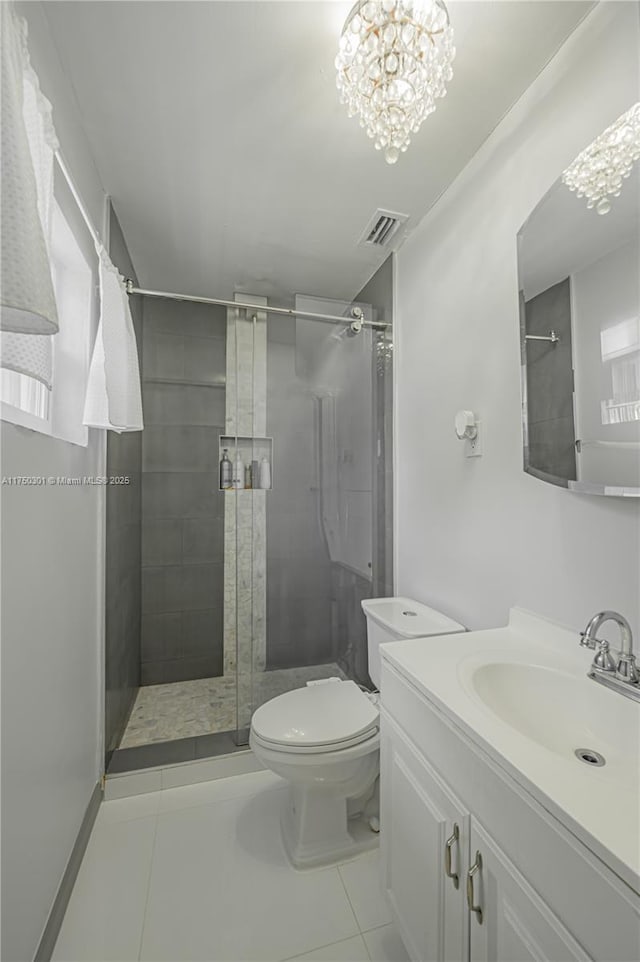 full bath featuring a chandelier, a stall shower, vanity, and toilet