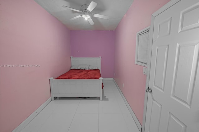 bedroom featuring light tile patterned floors, ceiling fan, and baseboards