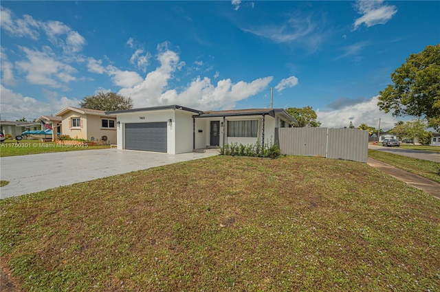 ranch-style house with stucco siding, a front yard, fence, a garage, and driveway