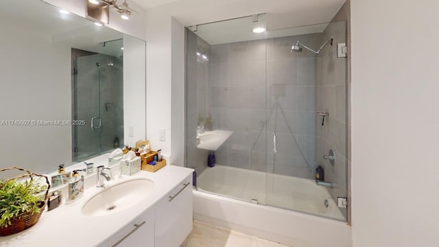 bathroom with shower / bath combination with glass door, tile patterned flooring, and vanity