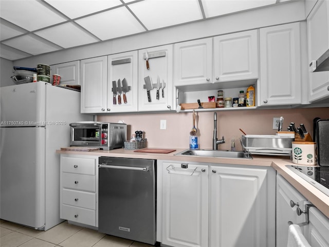 kitchen with dishwashing machine, a sink, white cabinetry, light countertops, and freestanding refrigerator