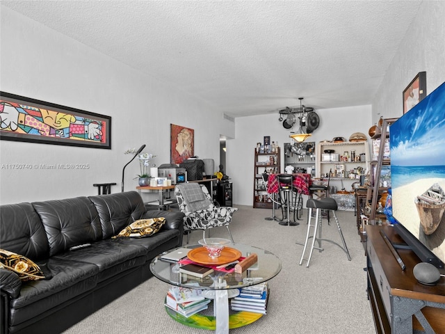 living room featuring carpet, a textured ceiling, and a bar