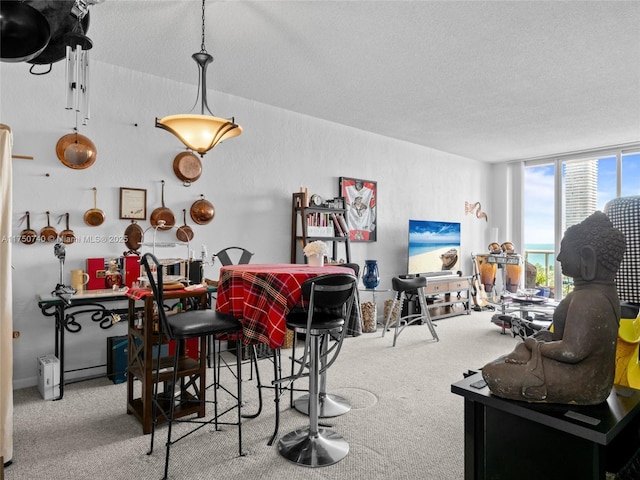 dining area with a textured ceiling and light colored carpet