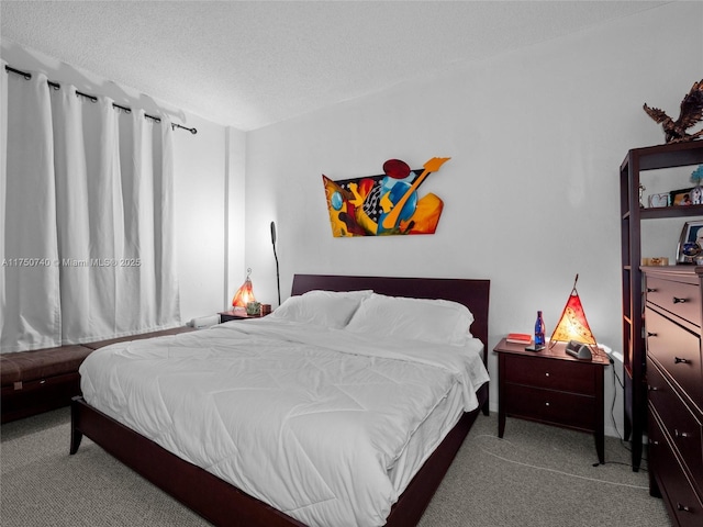 bedroom featuring carpet and a textured ceiling