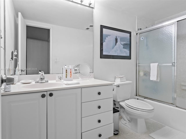 full bathroom with enclosed tub / shower combo, toilet, vanity, and tile patterned floors