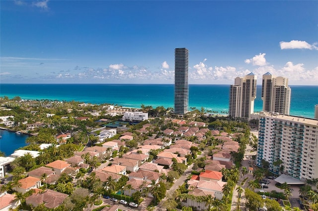 birds eye view of property with a view of city and a water view