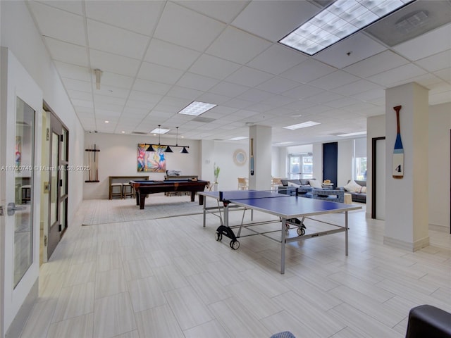 recreation room with billiards, a drop ceiling, and french doors