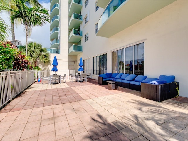 view of patio with outdoor lounge area and fence