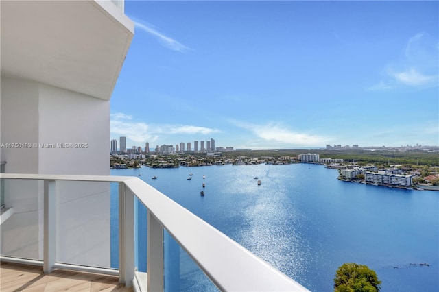 balcony featuring a view of city and a water view