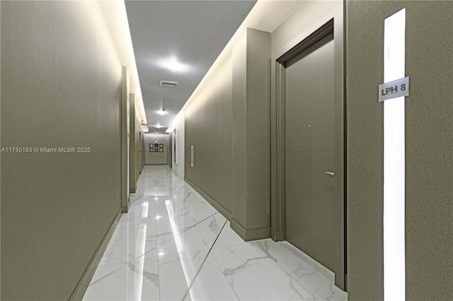 corridor with marble finish floor, visible vents, and baseboards