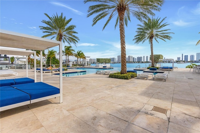 pool with a water view, a city view, and a patio