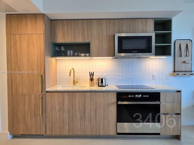 kitchen featuring stainless steel appliances, light stone counters, modern cabinets, and open shelves