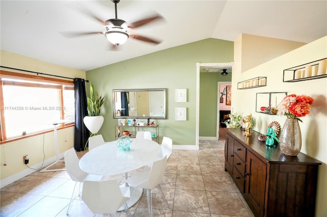 dining area featuring ceiling fan, baseboards, and vaulted ceiling