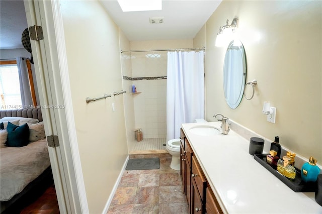 ensuite bathroom with a skylight, visible vents, toilet, connected bathroom, and vanity