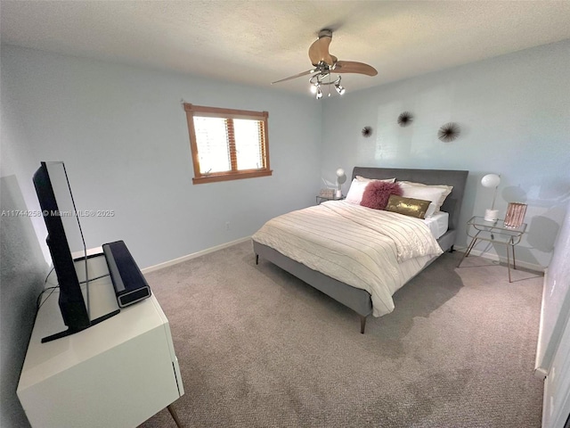 bedroom featuring a ceiling fan, carpet flooring, a textured ceiling, and baseboards