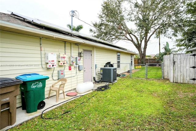 exterior space with a gate, fence, and central air condition unit