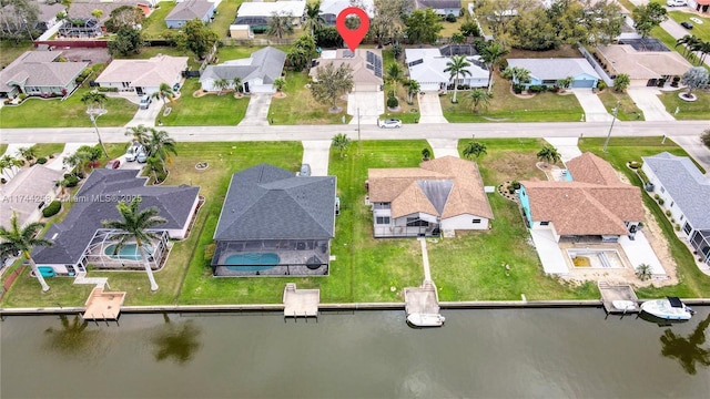 bird's eye view with a water view and a residential view