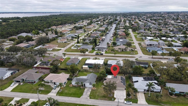 birds eye view of property featuring a water view and a residential view