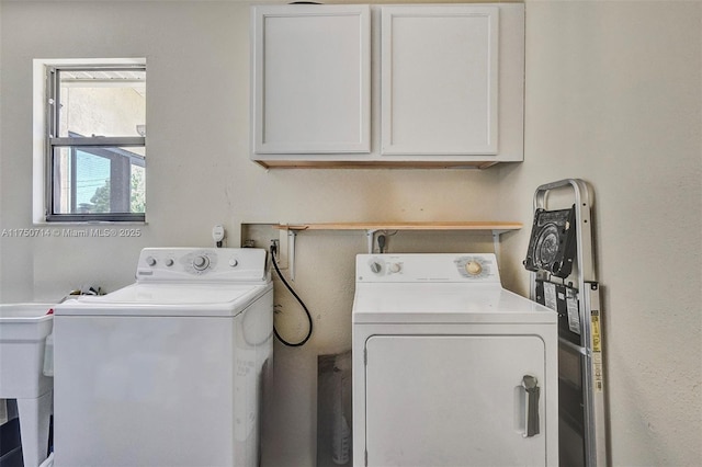 laundry room featuring cabinet space and washing machine and dryer