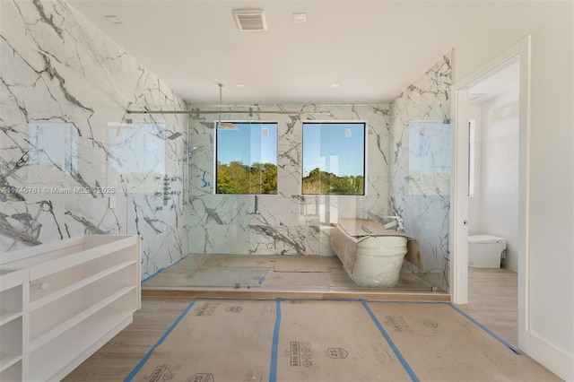 bathroom with visible vents, a marble finish shower, and toilet