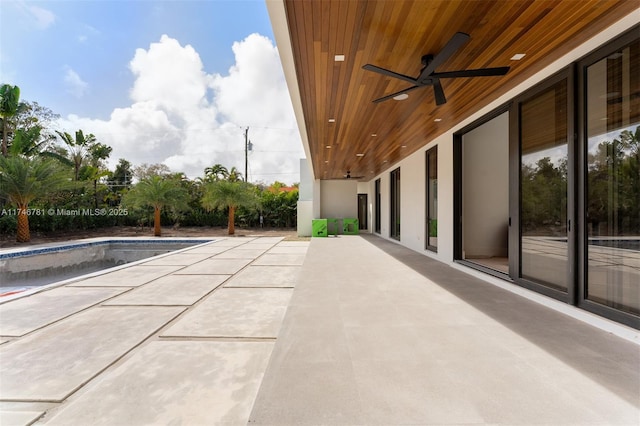 view of patio with an outdoor pool and ceiling fan