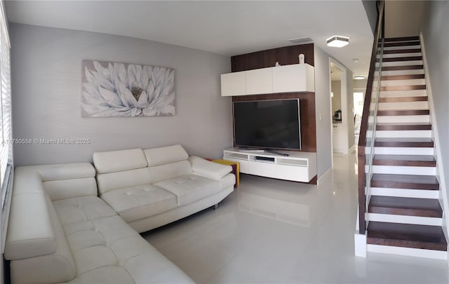 living room with stairway and visible vents