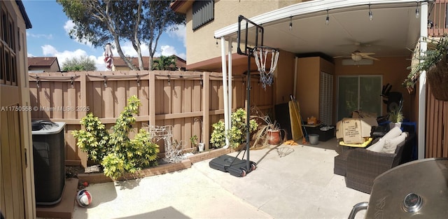 view of patio with a fenced backyard and a ceiling fan